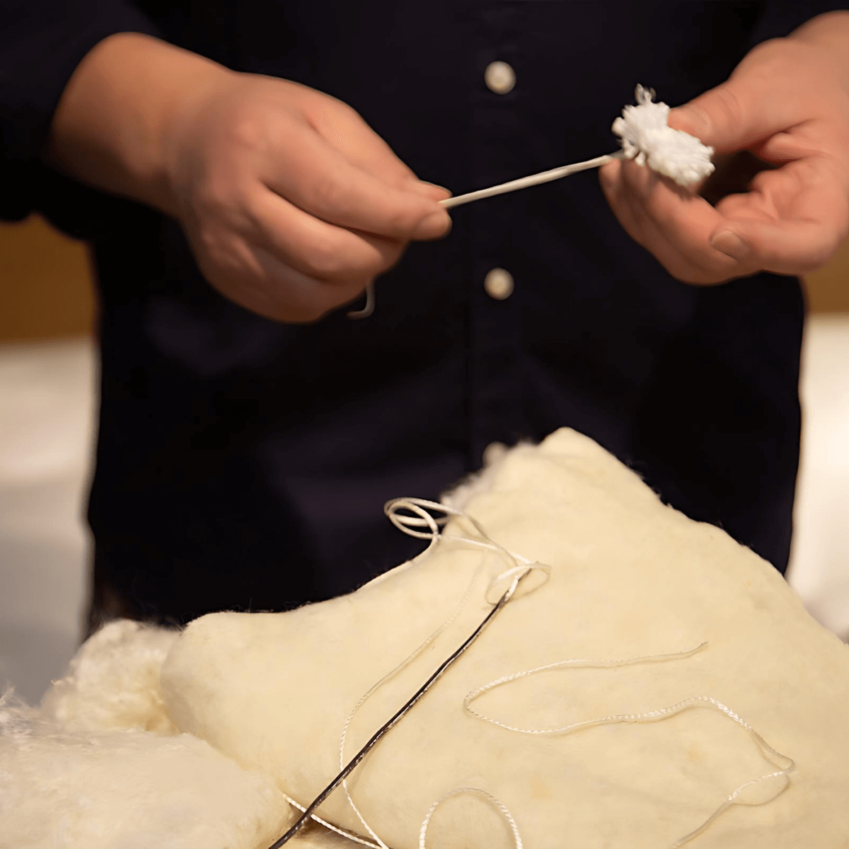 Artisan crafting English Royal Mattress with natural fillers and traditional methods.
