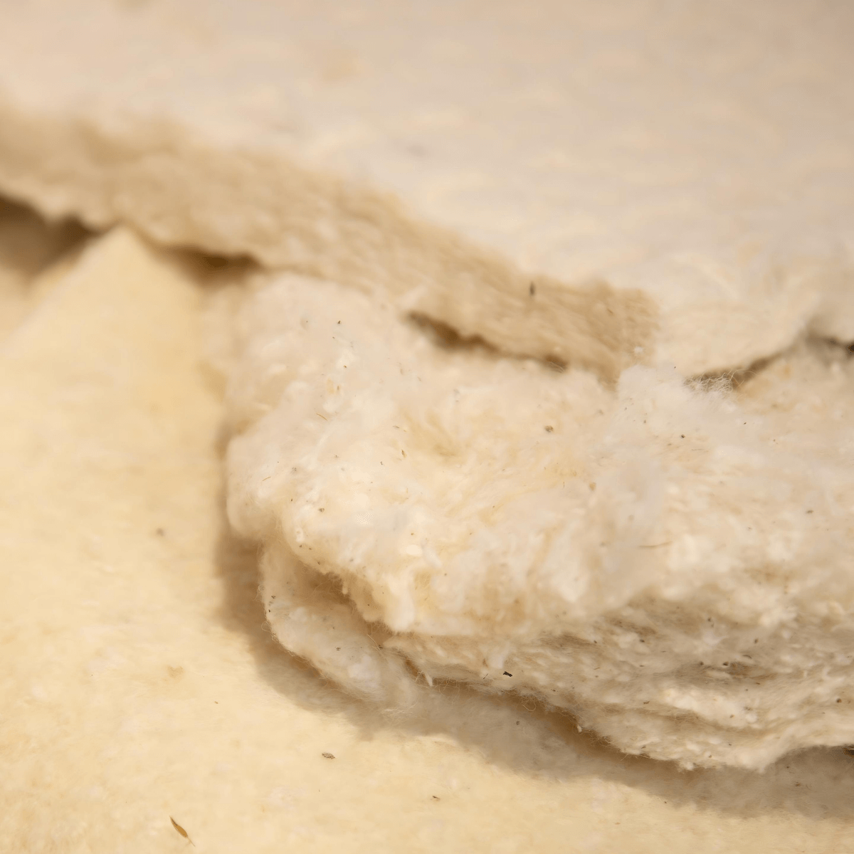 Close-up of natural, organic fillers used in handmade English Royal Mattress, emphasizing quality and traditional craftsmanship.